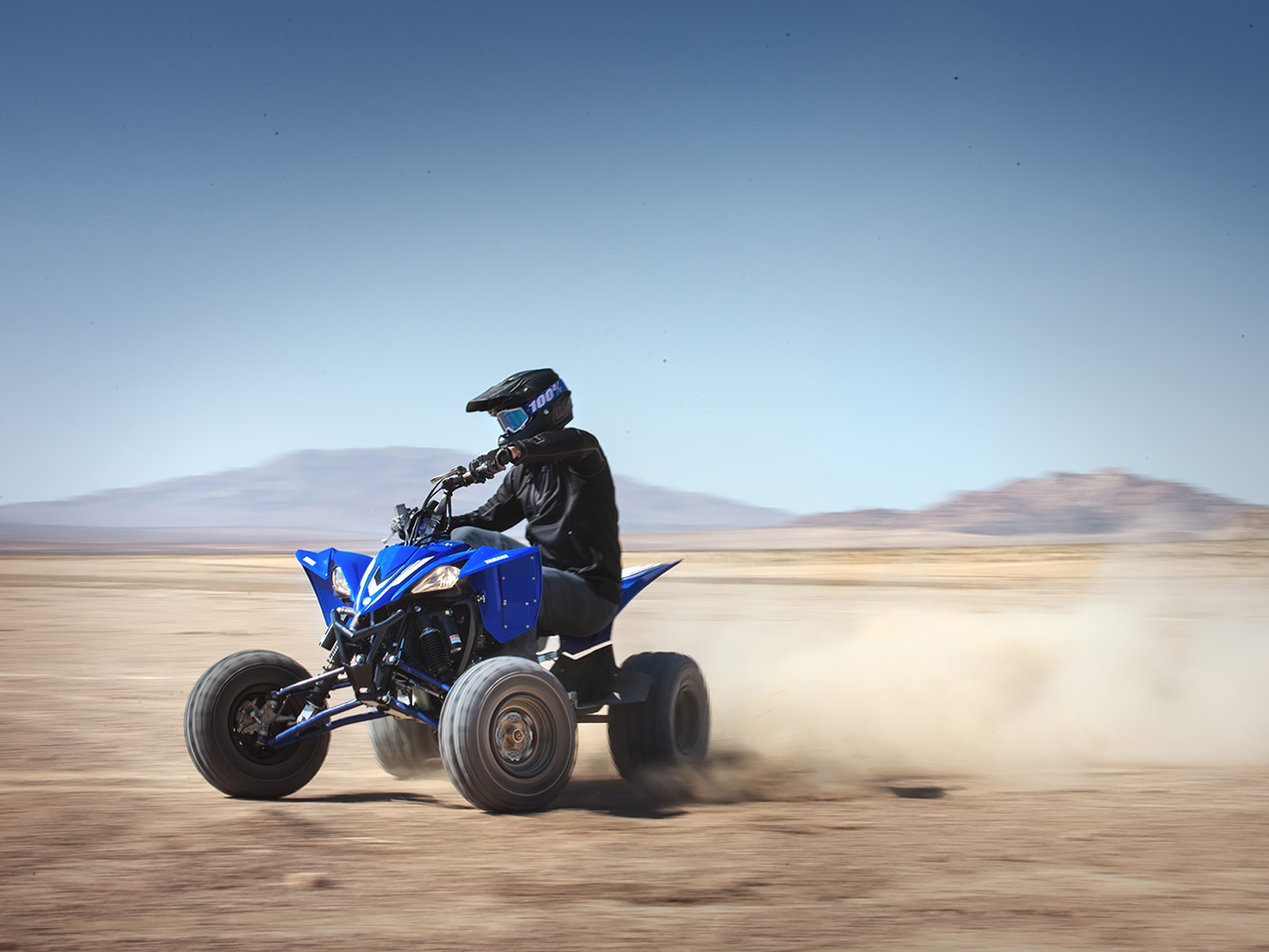 Yamaha YFZ450R in team yamaha blue colour , being ridden in the desert